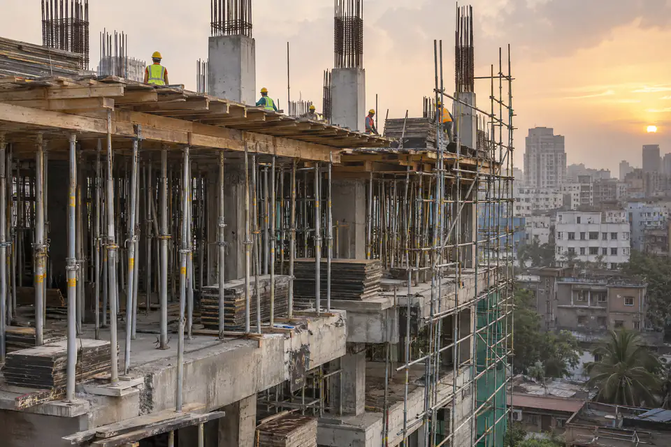 Illustration: adjustable steel props and tube scaffolding on a building under construction in Dhaka