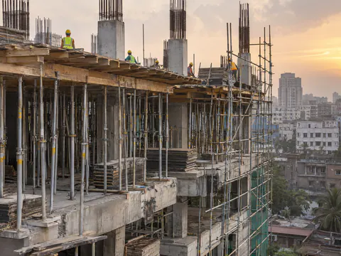 Illustration: adjustable steel props and tube scaffolding on a building under construction in Dhaka