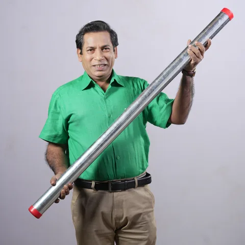 Mosharraf Karim, brand ambassador of Gram Bangla Tubes, holding a galvanized GI pipe