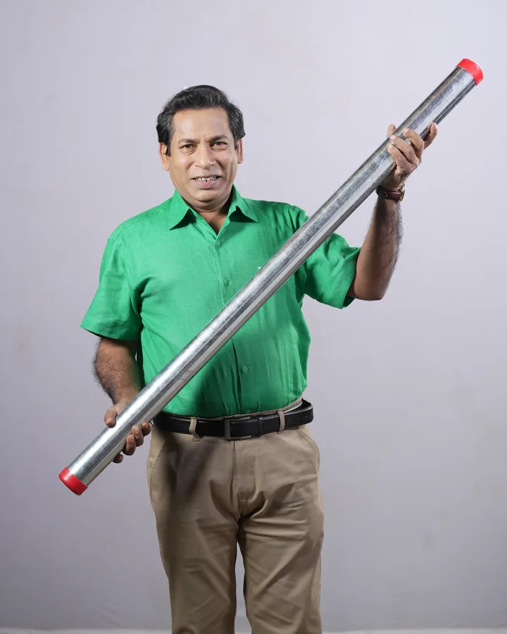 Mosharraf Karim, brand ambassador of Gram Bangla Tubes, holding a galvanized GI pipe