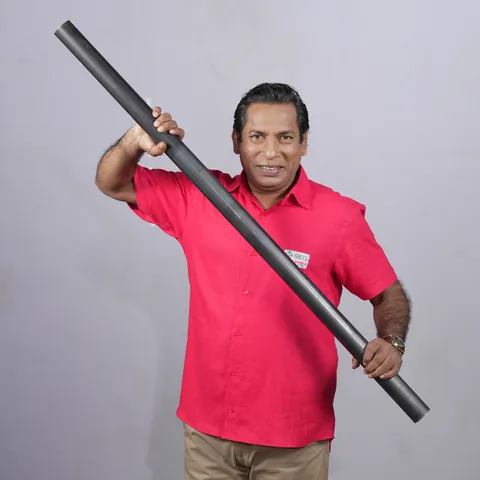 Mosharraf Karim, brand ambassador of Gram Bangla Tubes, holding a black MS steel pipe